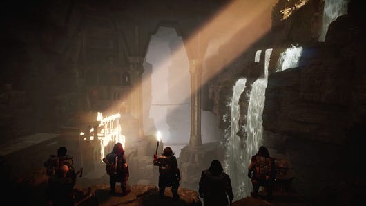 A group of dwarves looking at a huge cave in Return to Moria, with a shaft of light cutting across the view of an arch.